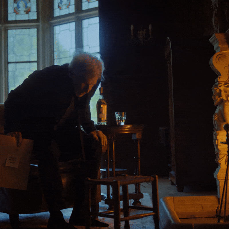 Harrison Ford by the fire drinking Glenmorangie Whisky